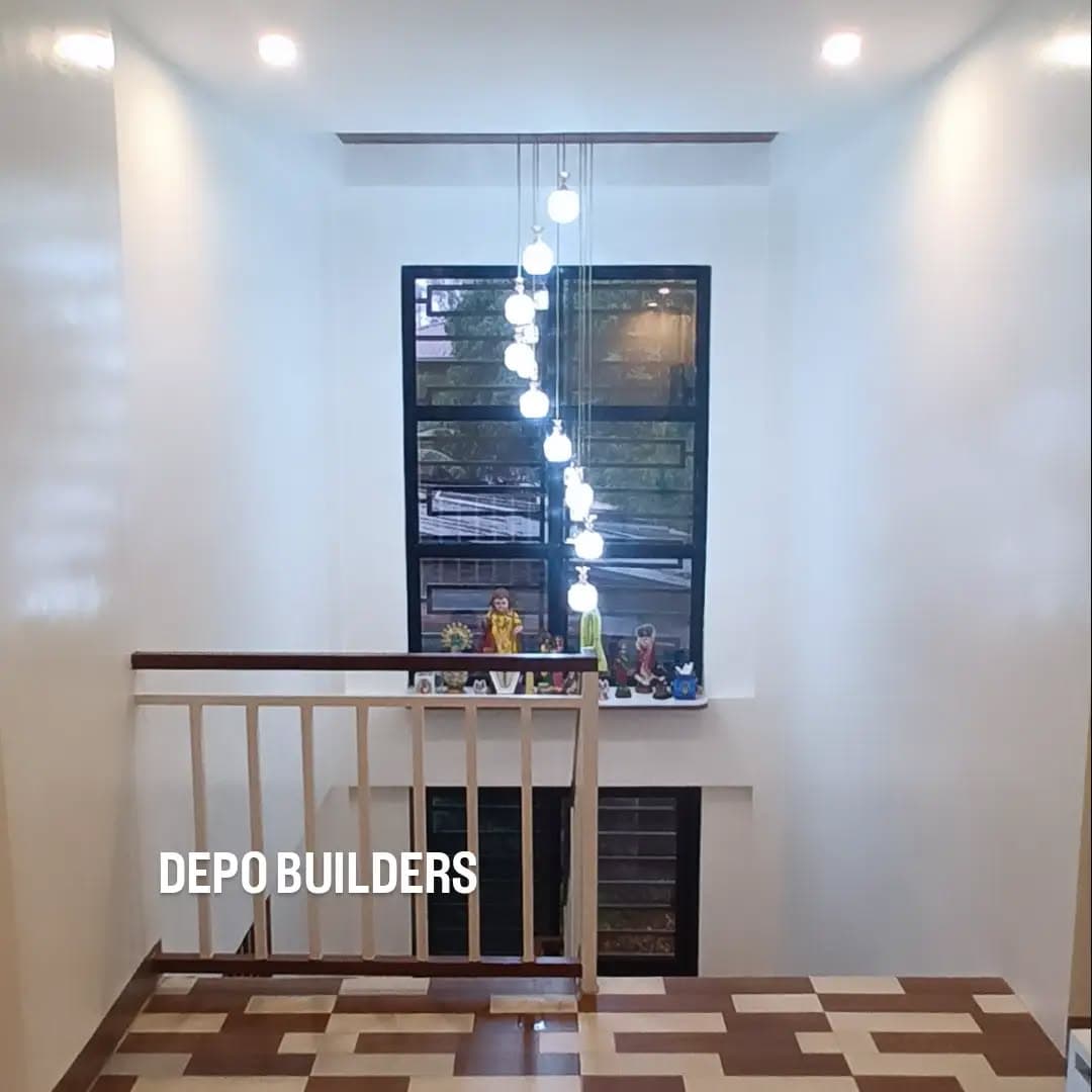 Stair landing with a pendant light cluster and patterned tile floor